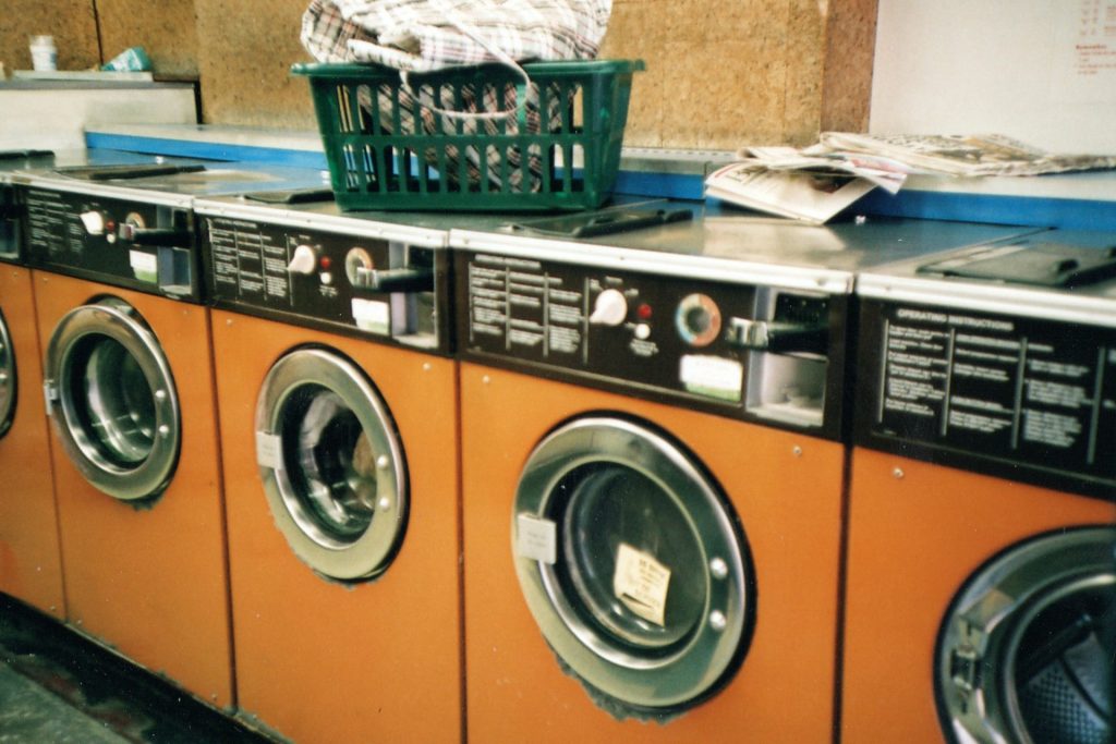 green plastic basket on front load washing machine